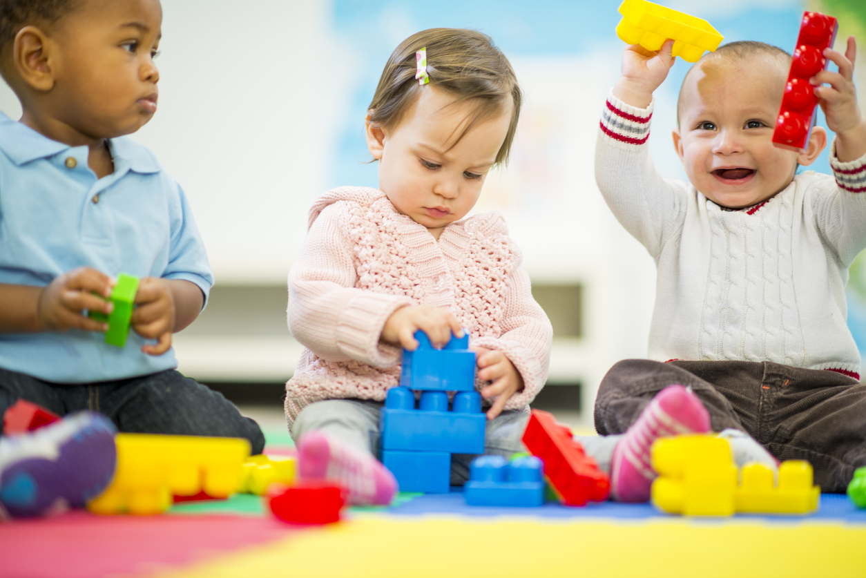 Diverse group of babies playing.