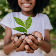 Girl holding plant