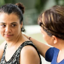Girl and woman talking and offering support.