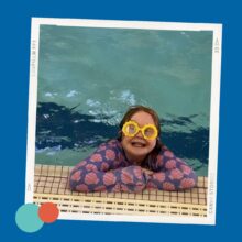 Graphic with a blue background. A photo in a white frame shows a smiling child wearing yellow goggles and a pink swim shirt with shell patterns, resting her arms on the edge of a pool. There are teal and orange dots at the bottom left corner of the photo frame.